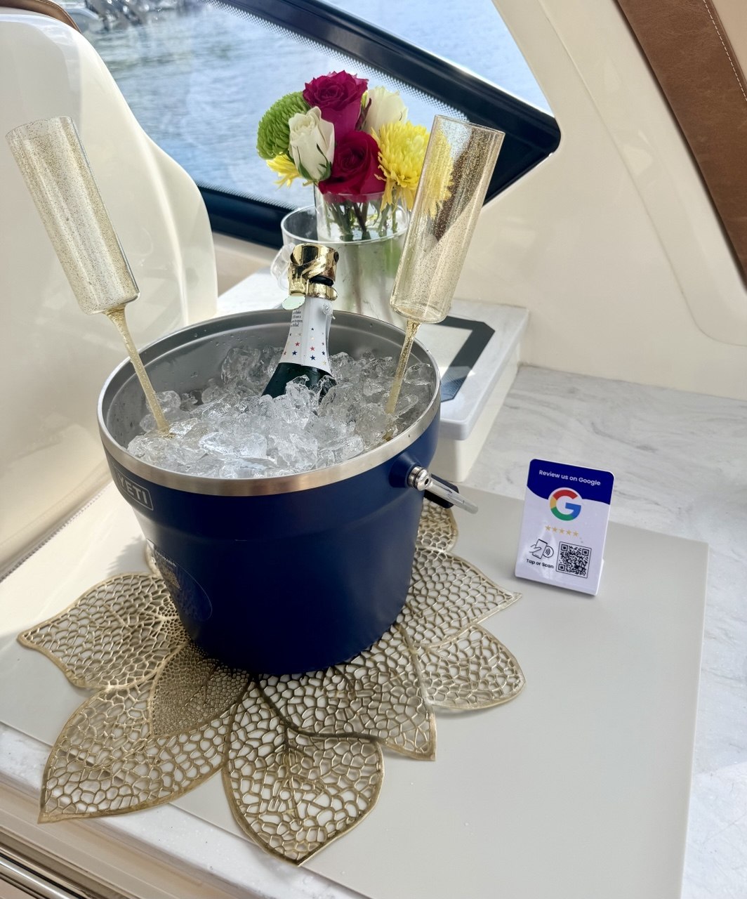 Champagne bucket with ice and gold flutes aboard The Bougie Girl