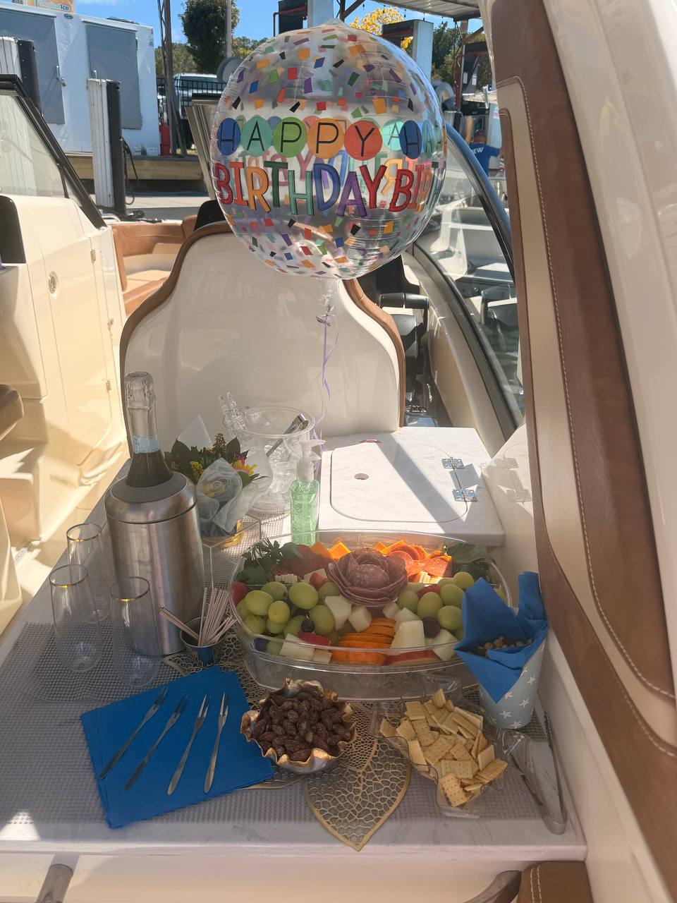 Birthday celebration setup with champagne and grazing display aboard a charter boat