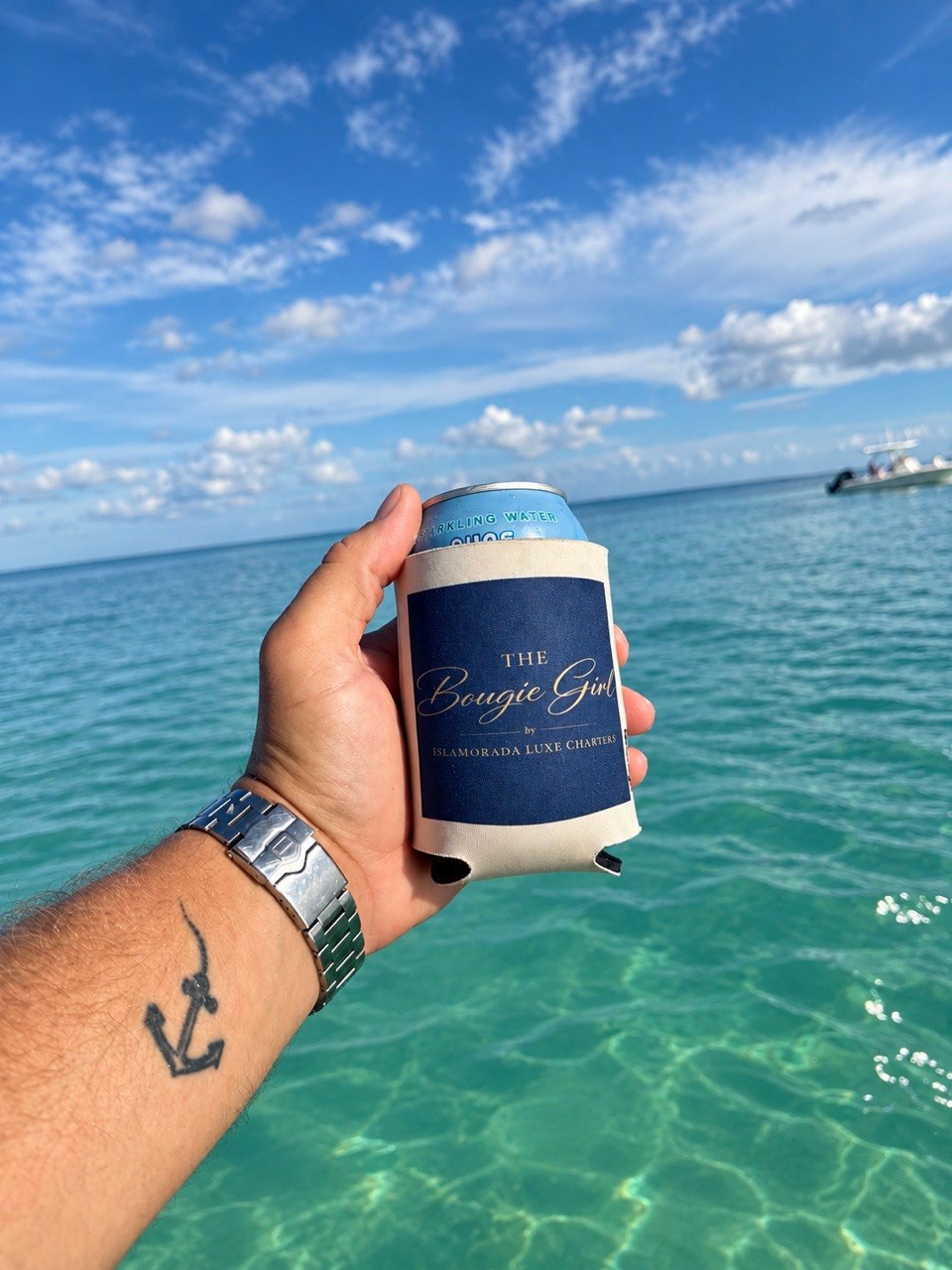 The Bougie Girl branded drink sleeve over turquoise Islamorada sandbar water