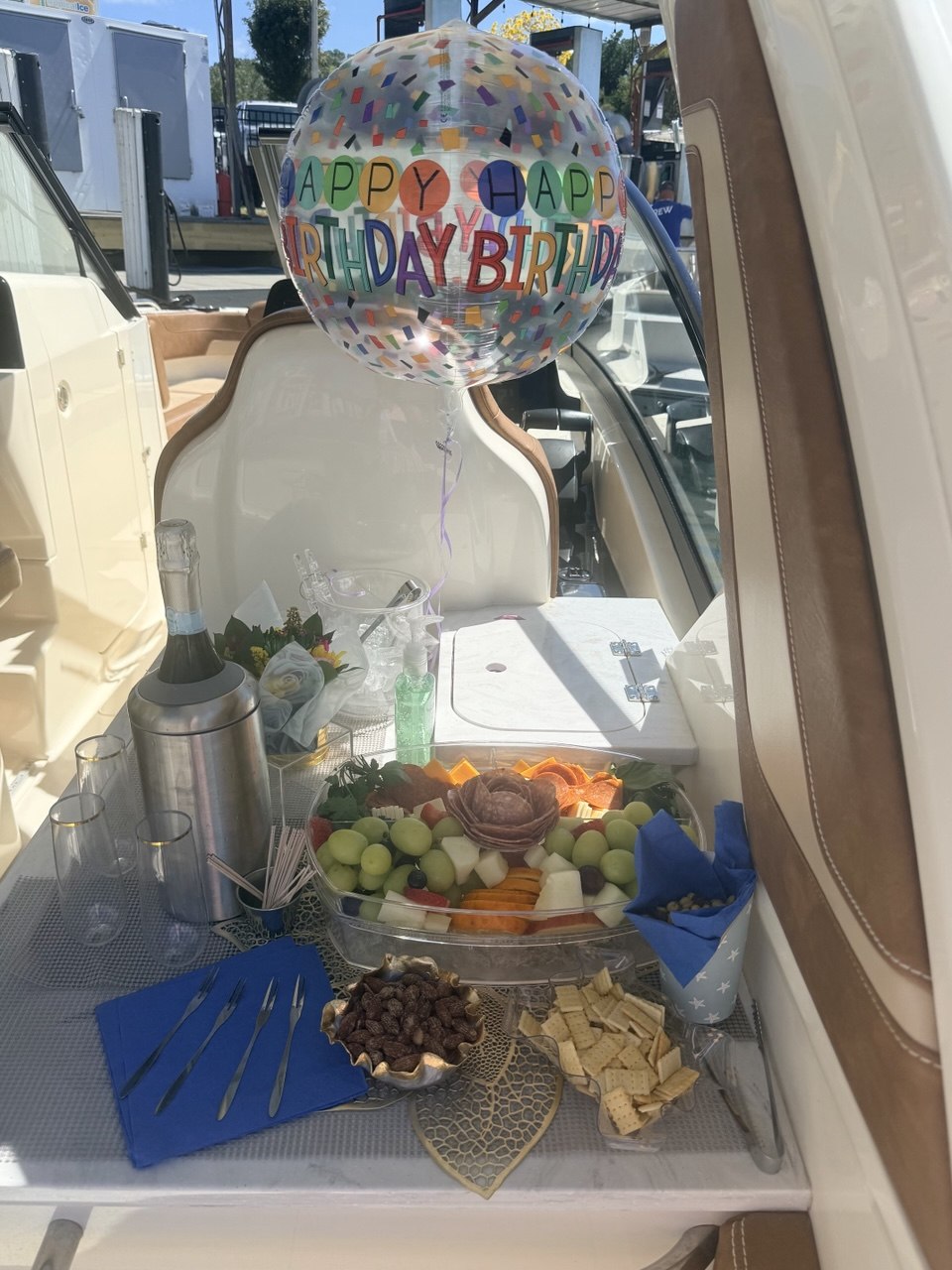 Birthday celebration setup aboard The Bougie Girl with charcuterie and champagne
