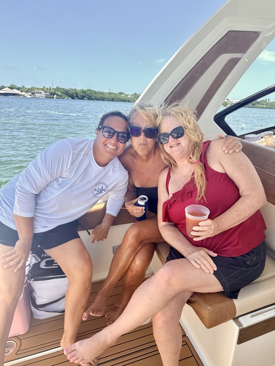 Three friends enjoying their day aboard The Bougie Girl in Islamorada