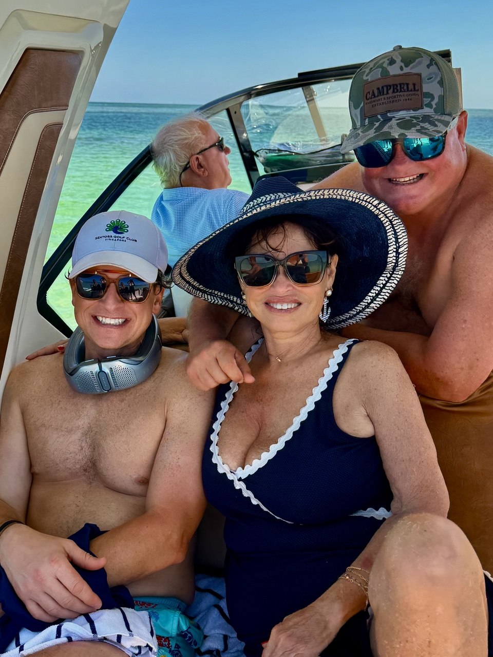 Friends smiling together aboard The Bougie Girl on a sunny day in Islamorada