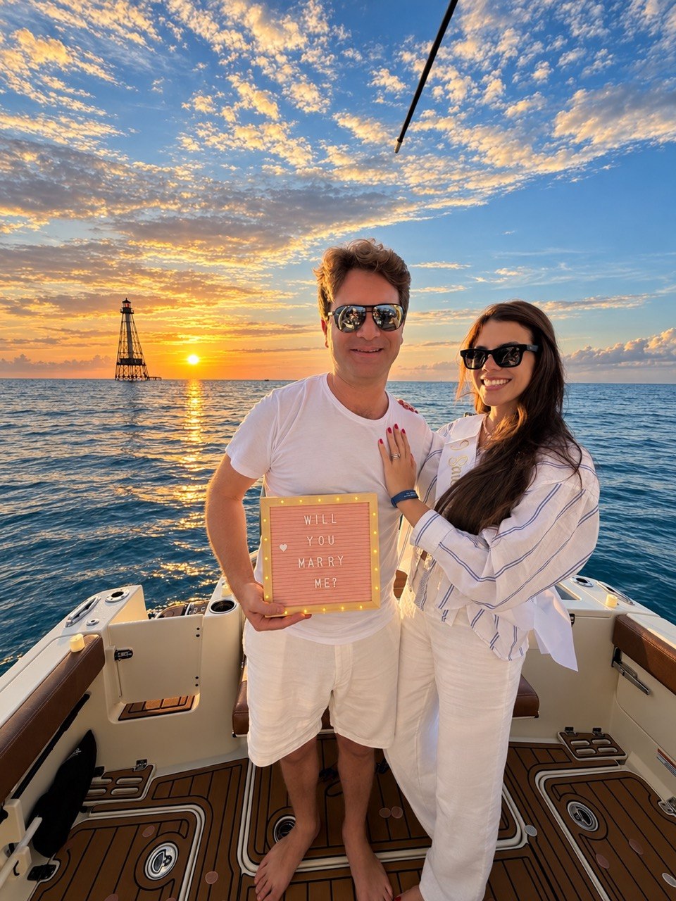 Couple celebrating a proposal at sunset near Alligator Reef Lighthouse