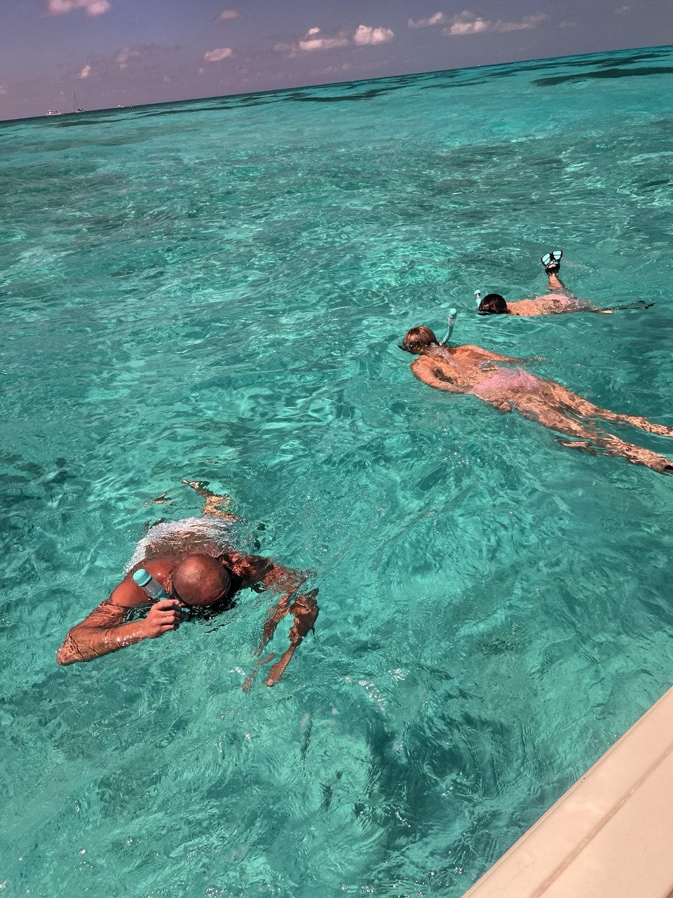 Three guests snorkeling in clear turquoise Florida Keys water