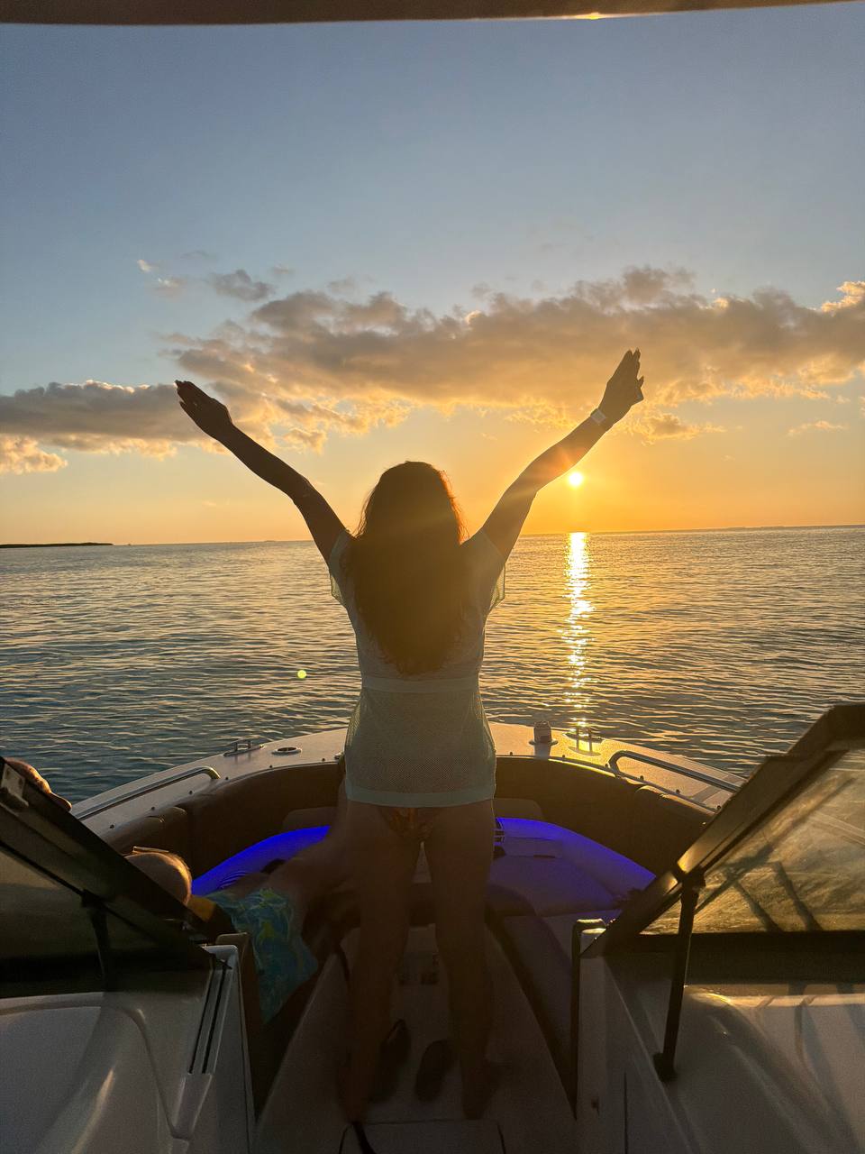 Guest enjoying the sunset on The Bougie Girl golden hour cruise